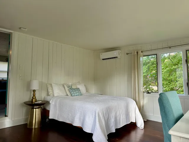 a bedroom with a bed and a chair