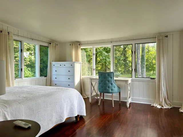 a bedroom with a bed and a chair