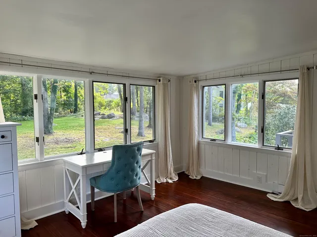a workspace with wooden floor and a window