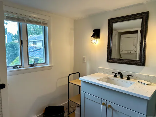 a bathroom with a toilet sink vanity and mirror