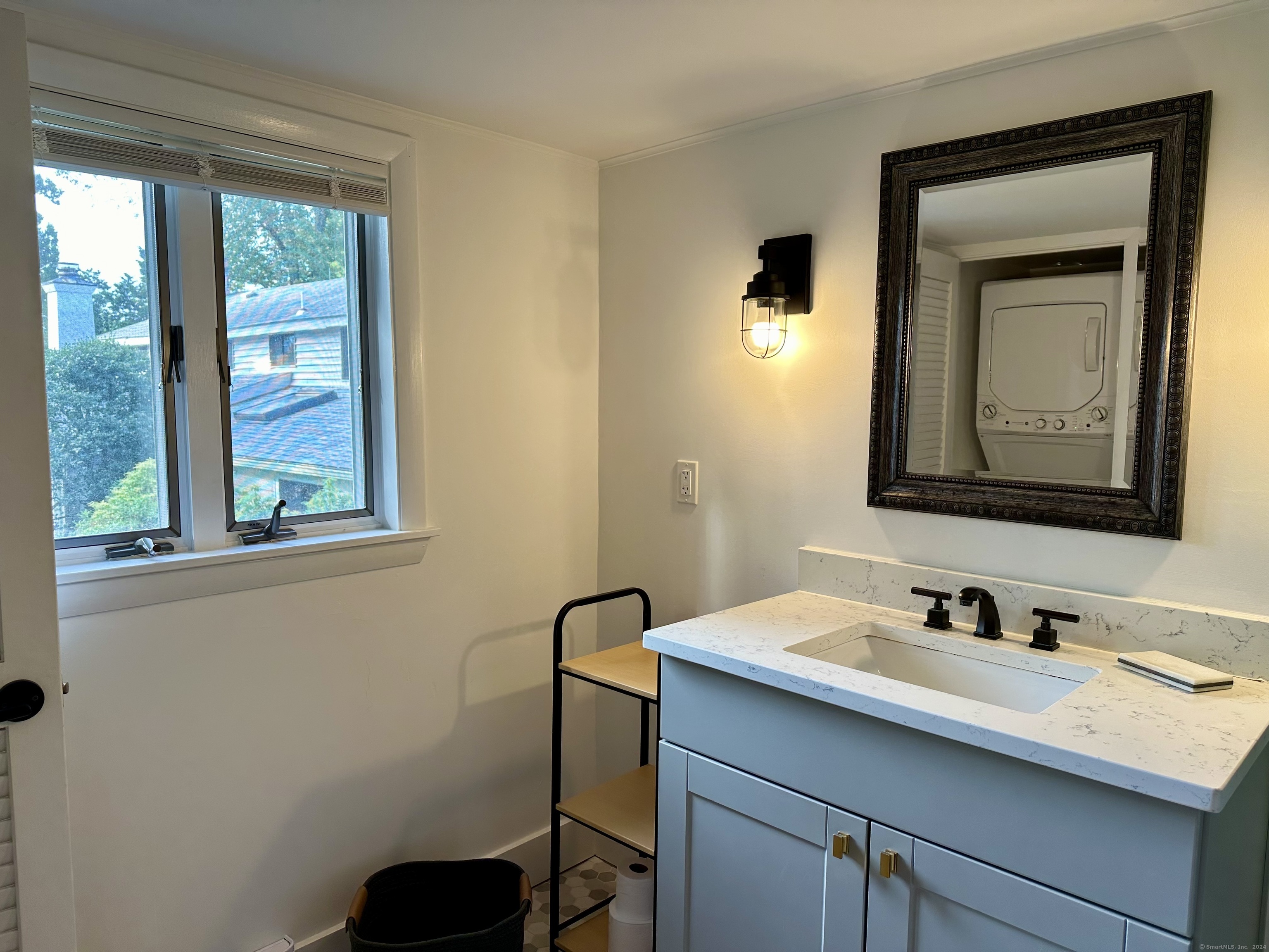 36 Tuxis Road Madison, CT 06443 - Photo 16 of 16 a bathroom with a toilet sink vanity and mirror