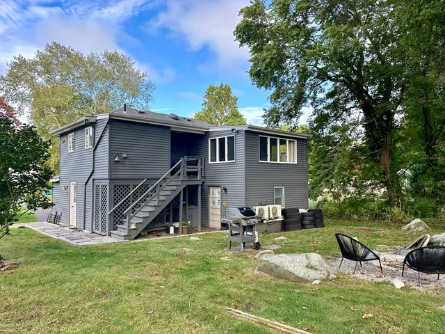 a front view of a house with a yard table and chairs