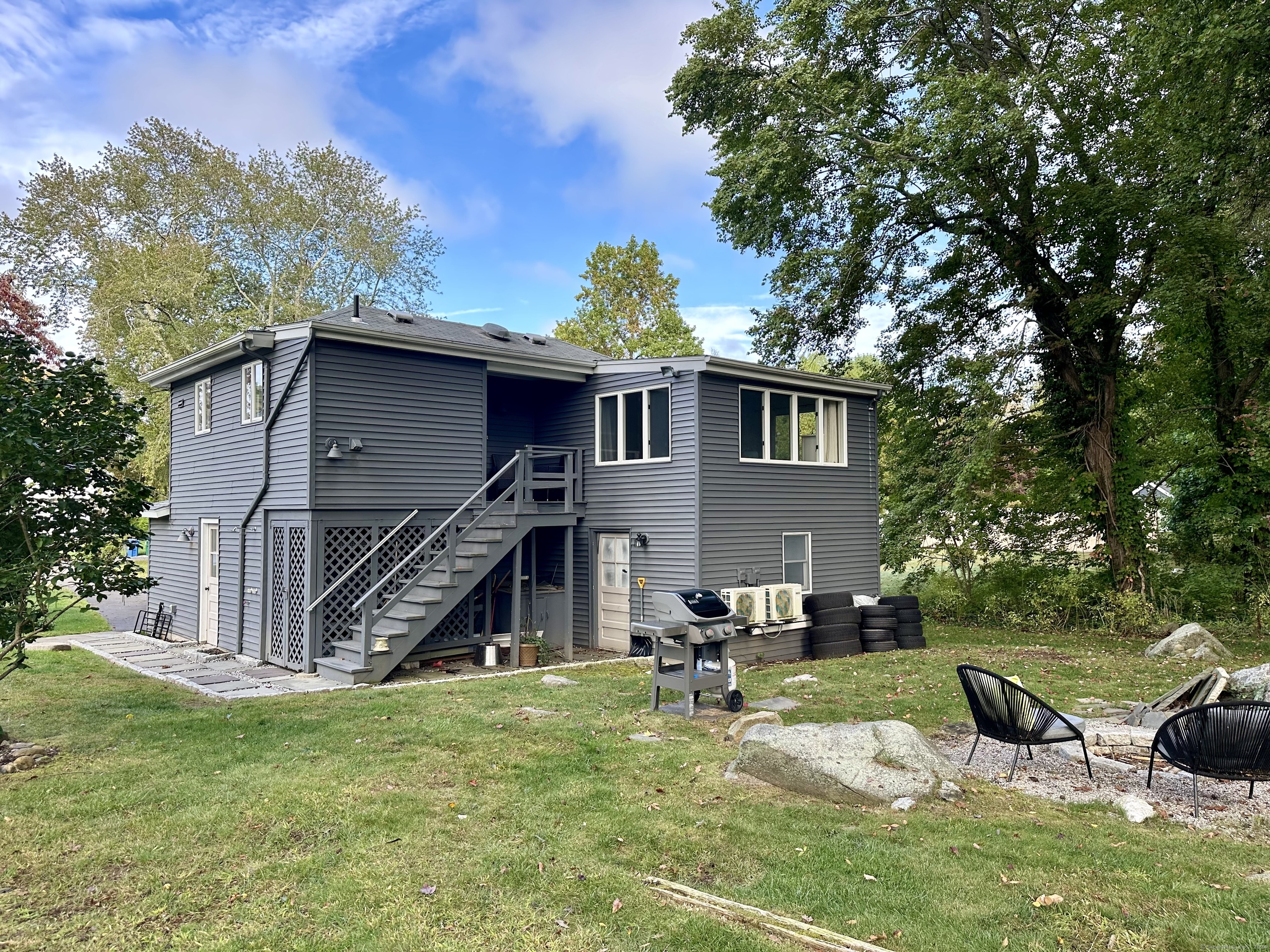 36 Tuxis Road Madison, CT 06443 - Photo 2 of 16 a front view of a house with a yard table and chairs