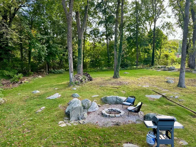 a backyard of a house with table and chairs