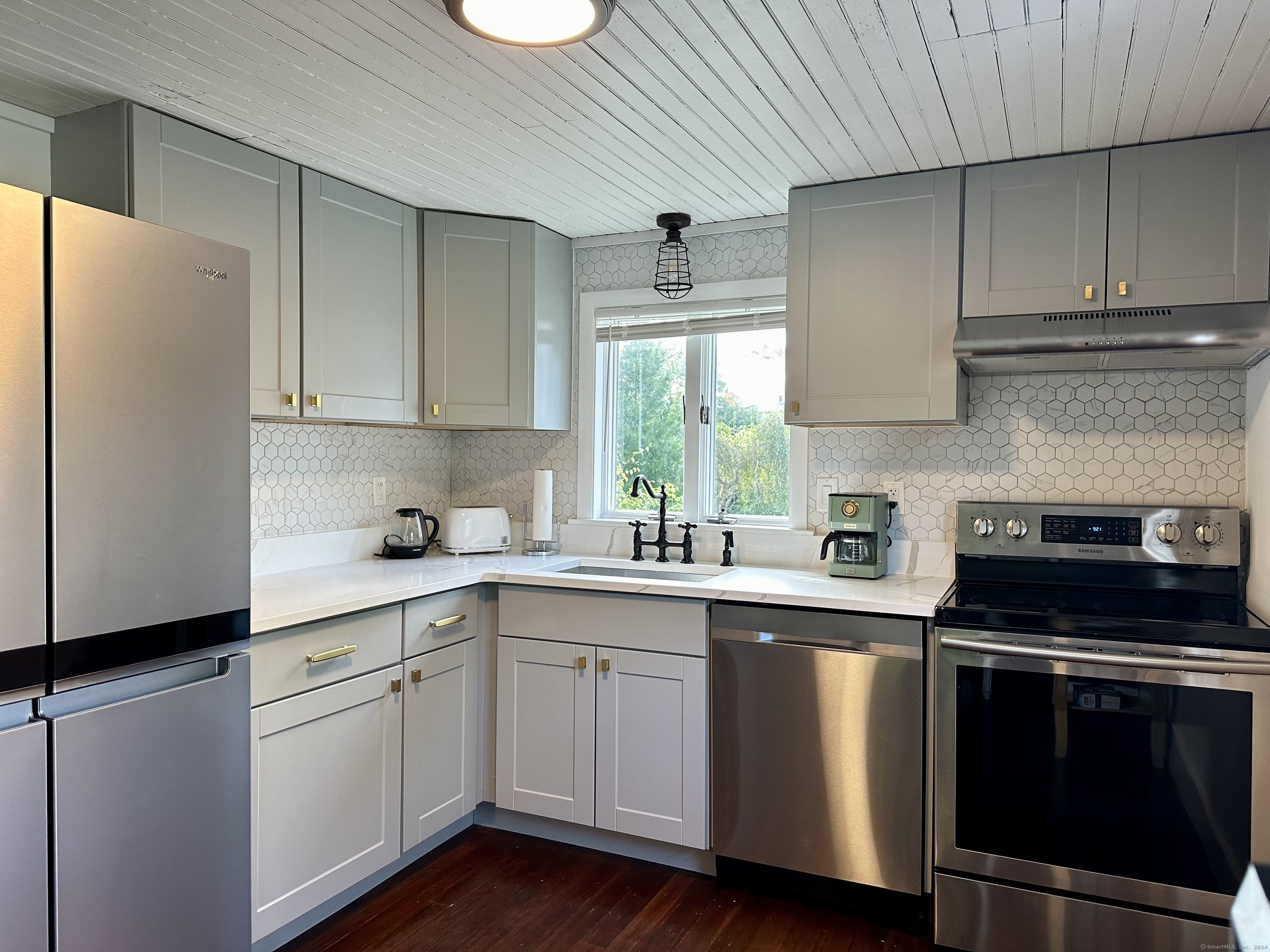 36 Tuxis Road Madison, CT 06443 - Photo 5 of 16 a kitchen with a sink a stove and cabinets