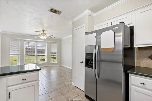 a open kitchen with granite countertop a refrigerator and a sink