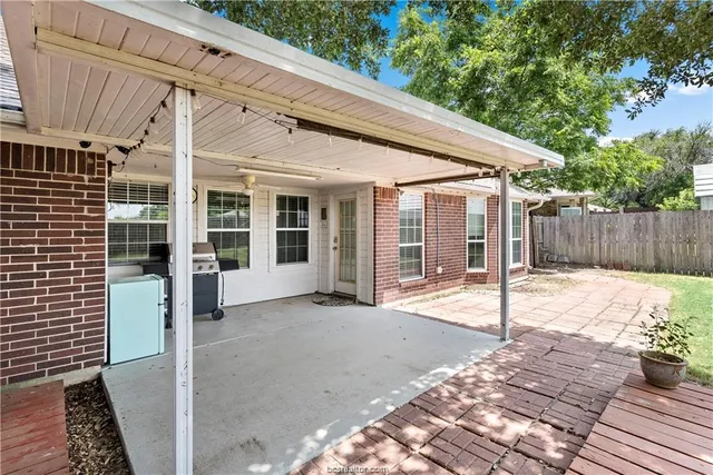 a view of a house with a backyard and floor to ceiling window