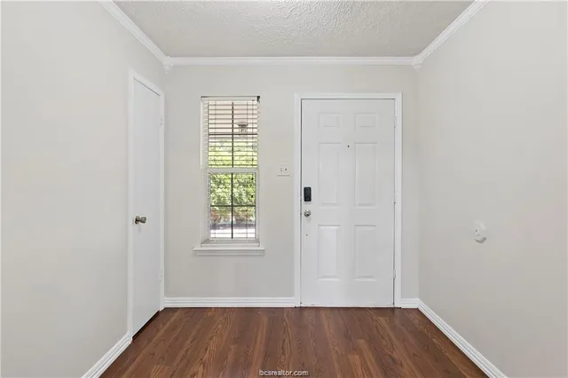 a view of a room with wooden floor and window