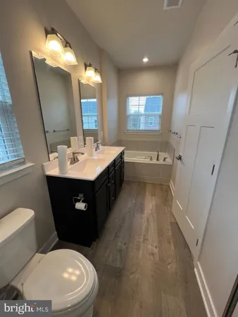 a spacious bathroom with double vanity and a mirror