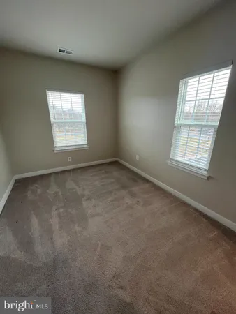 a view of an empty room with windows