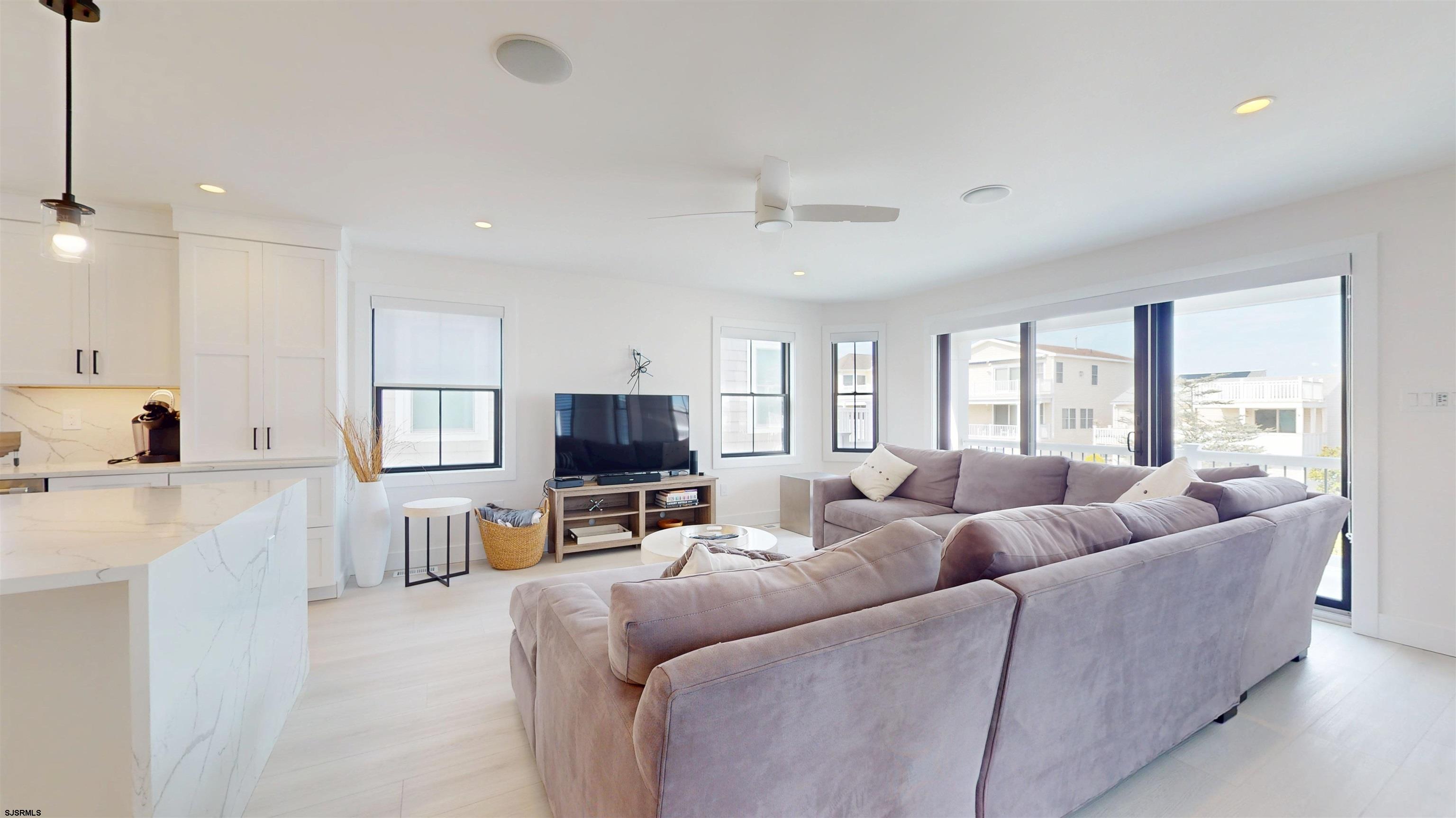 342 38th Street South Brigantine, NJ 08203 - Photo 13 of 86 a living room with furniture a flat screen tv and a large window
