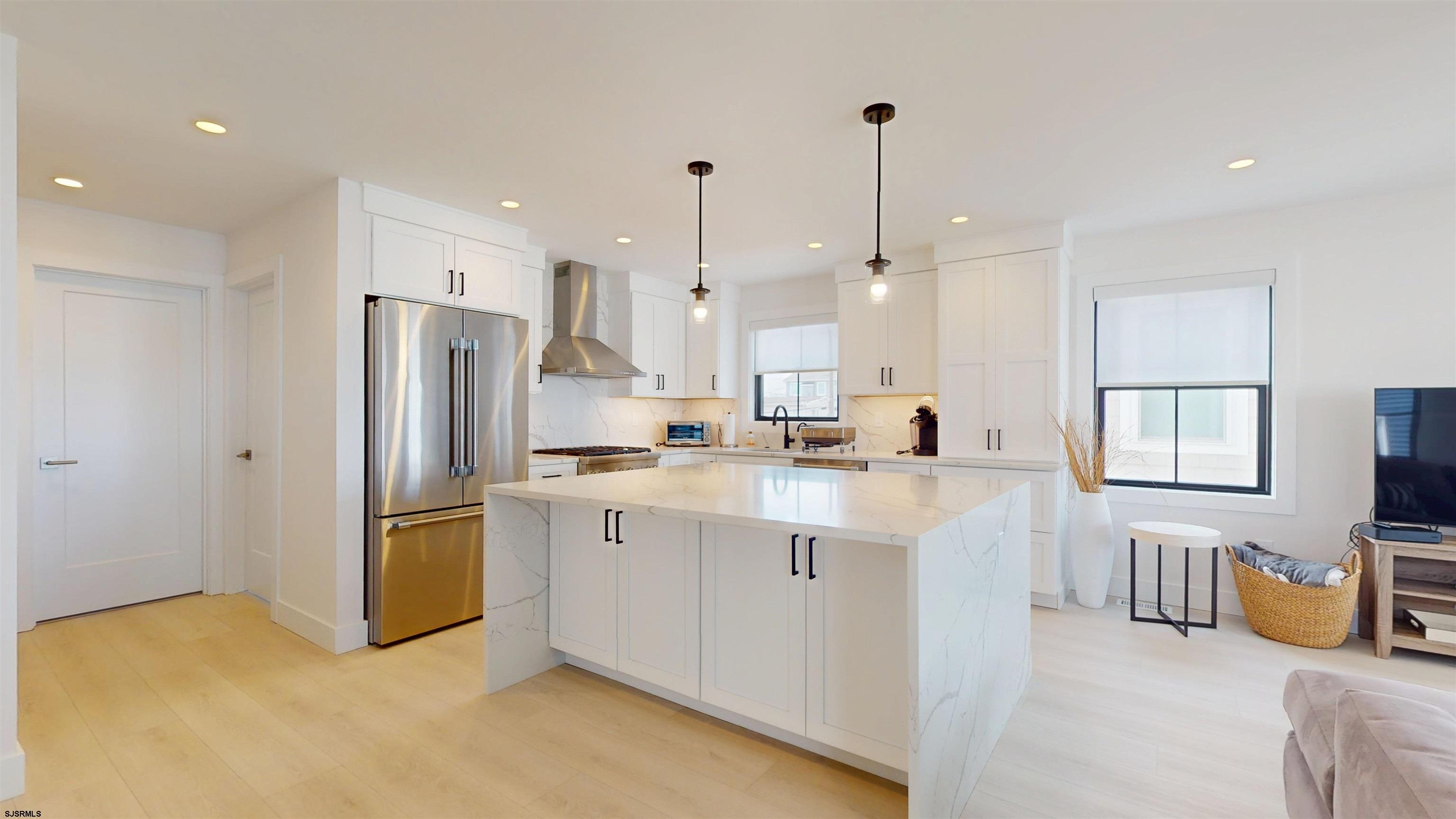 342 38th Street South Brigantine, NJ 08203 - Photo 16 of 86 a kitchen with stainless steel appliances granite countertop a refrigerator a sink and a stove