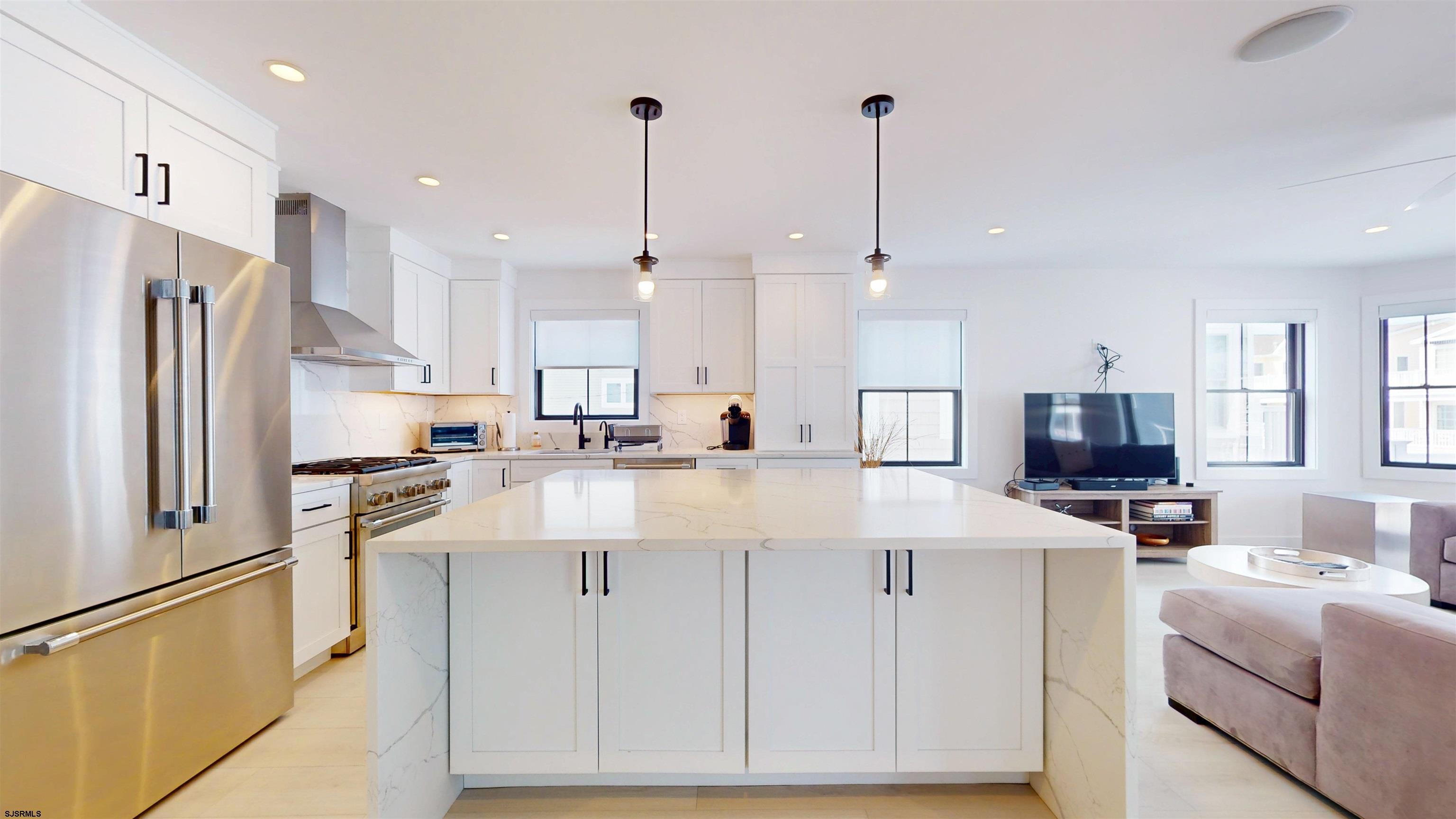 342 38th Street South Brigantine, NJ 08203 - Photo 25 of 86 a kitchen with stainless steel appliances kitchen island granite countertop a refrigerator a stove a sink a oven and a center island