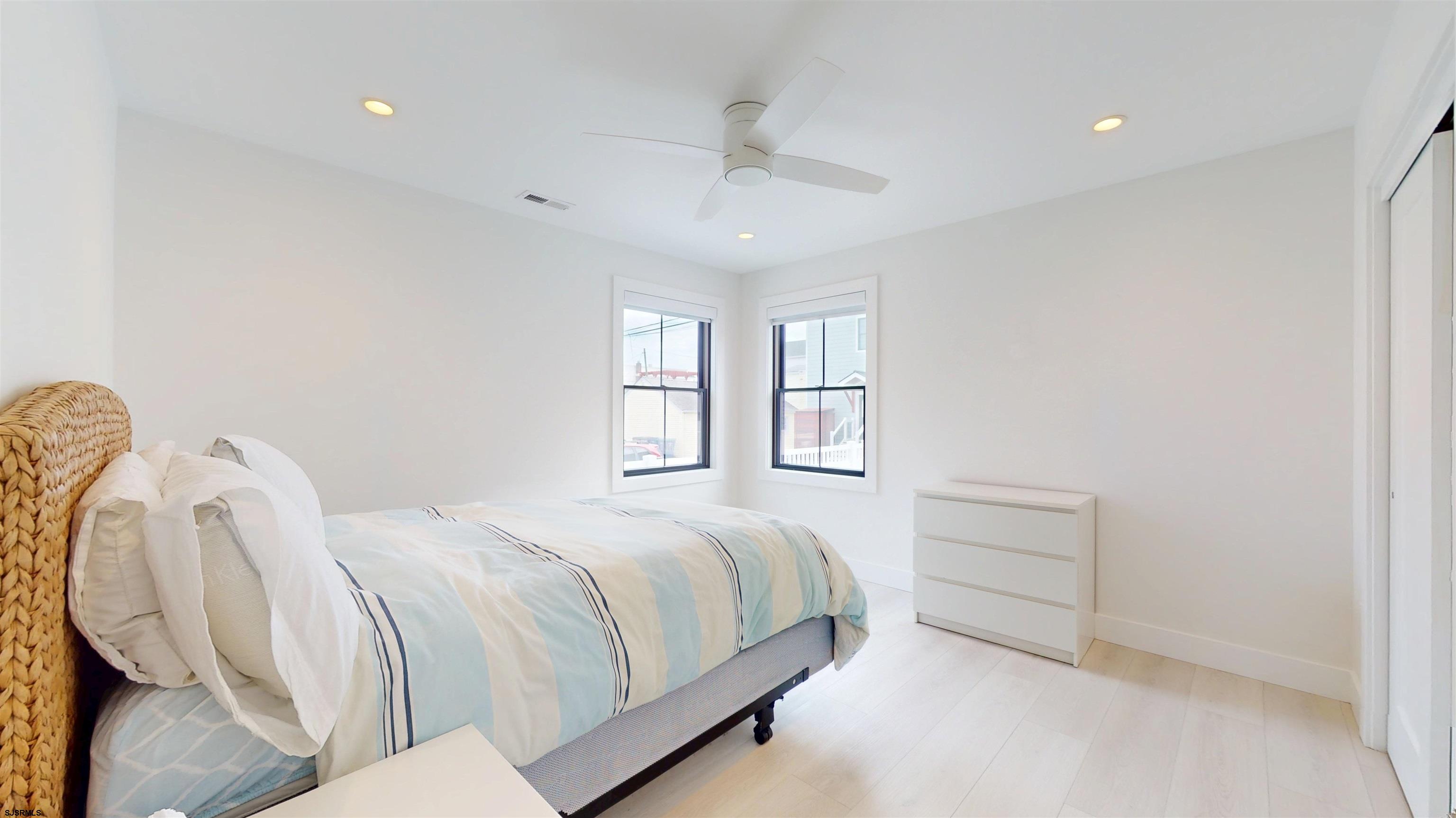 342 38th Street South Brigantine, NJ 08203 - Photo 69 of 86 a bedroom with a bed and a chandelier