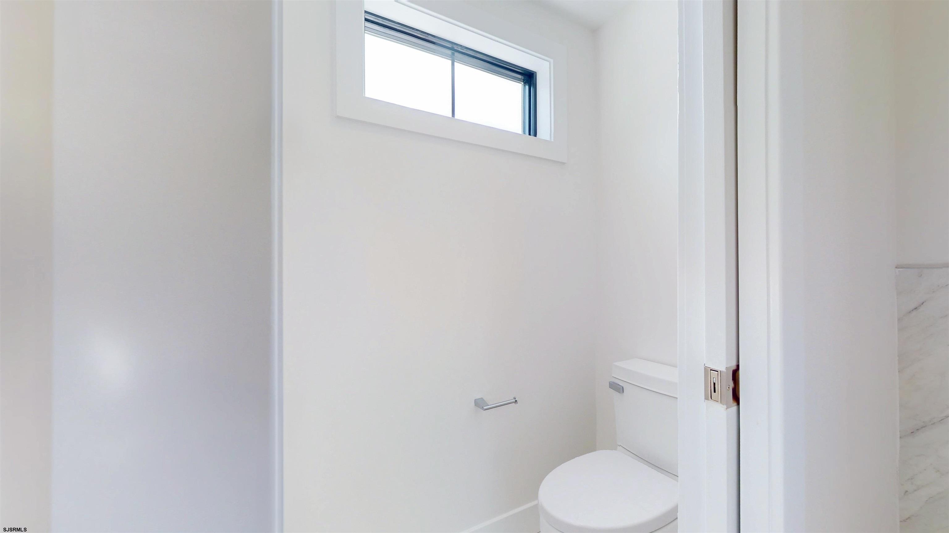 342 38th Street South Brigantine, NJ 08203 - Photo 72 of 86 a white toilet sitting next to a window
