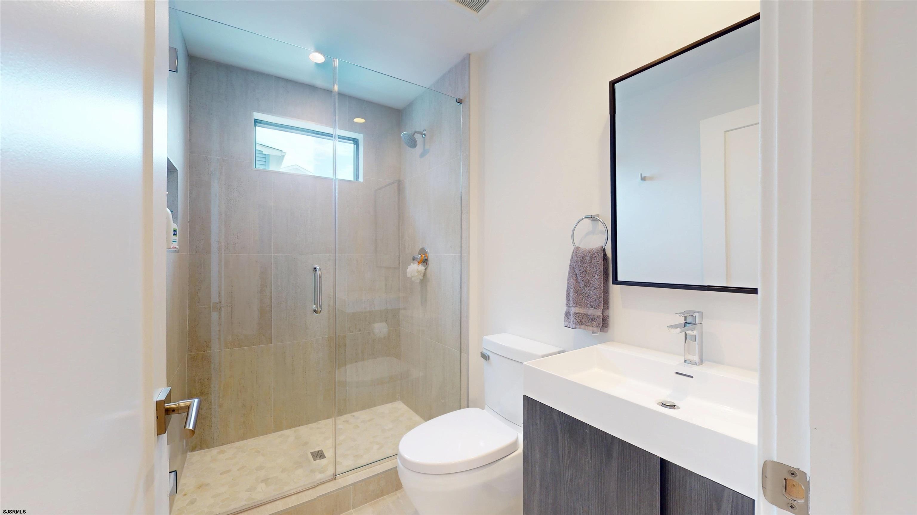 342 38th Street South Brigantine, NJ 08203 - Photo 77 of 86 a bathroom with a sink a toilet and shower