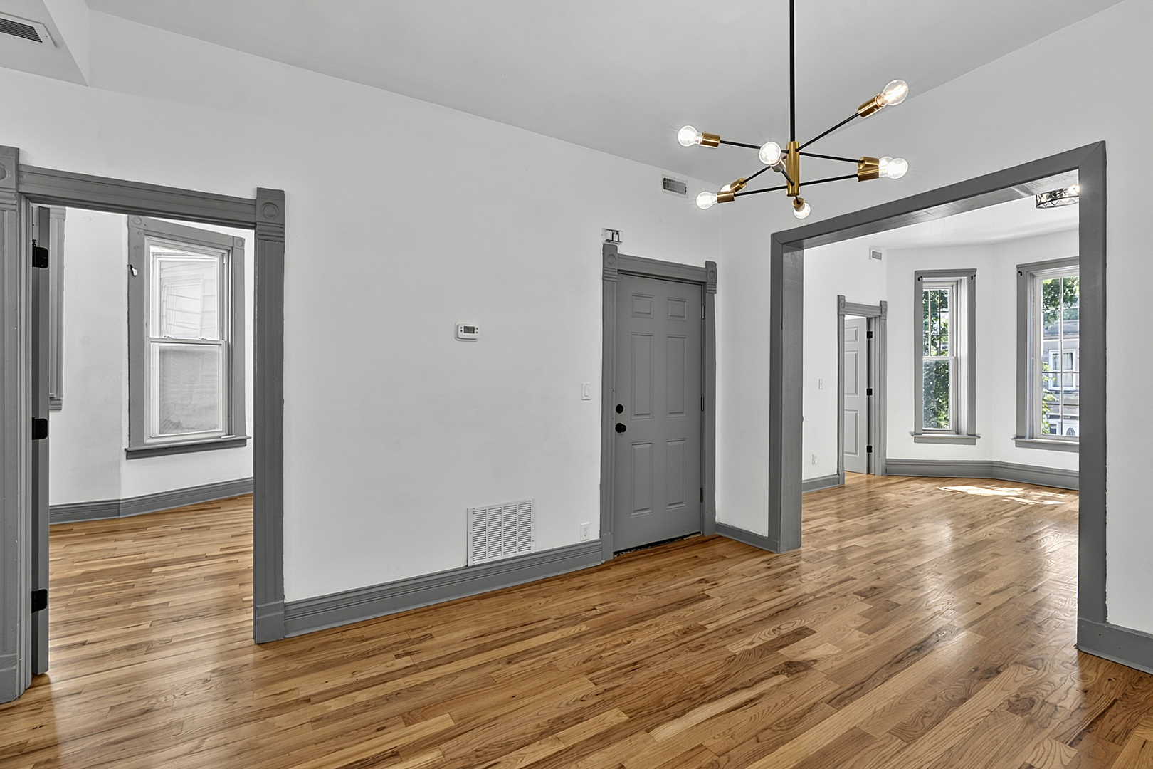 6602 South Marquette Road Chicago, IL 60637 - Photo 7 of 24 a view of a room with wooden floor a ceiling fan