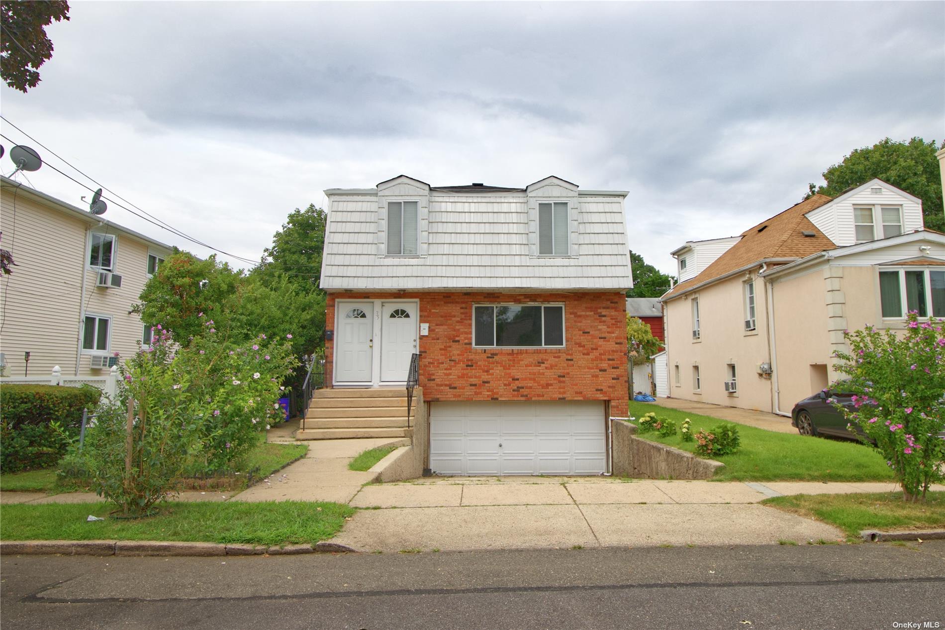 35 Graywood Road Port Washington, NY 11050 - Photo 1 of 1 a front view of a house with a yard and a garage