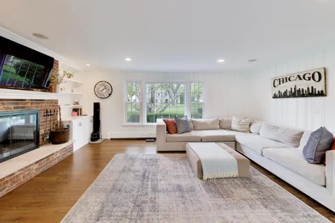 a view of a room with wooden floor and windows