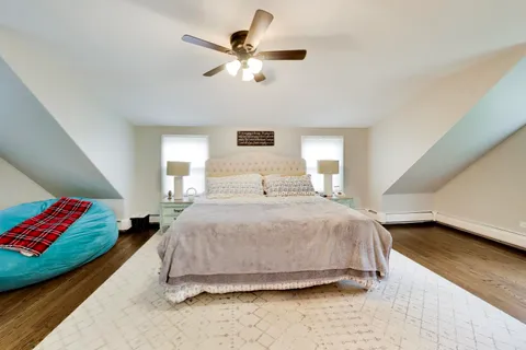 a view of a house with a bed and wooden floor