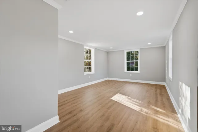 an empty room with windows and closet