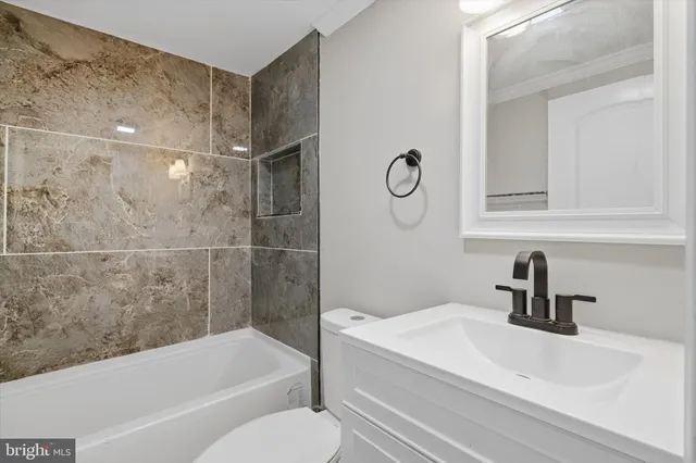 a bathroom with a sink a toilet and a bathtub