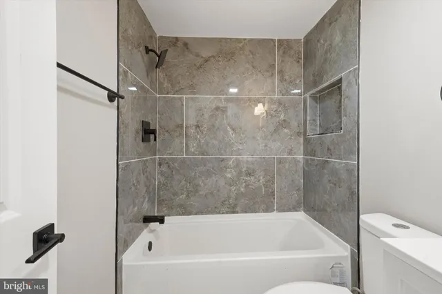 a bathroom with a bathtub and a shower