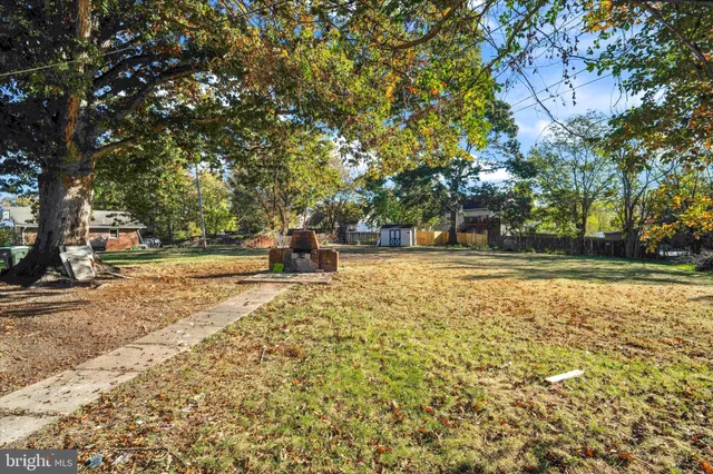 a view of yard with swimming pool and trees