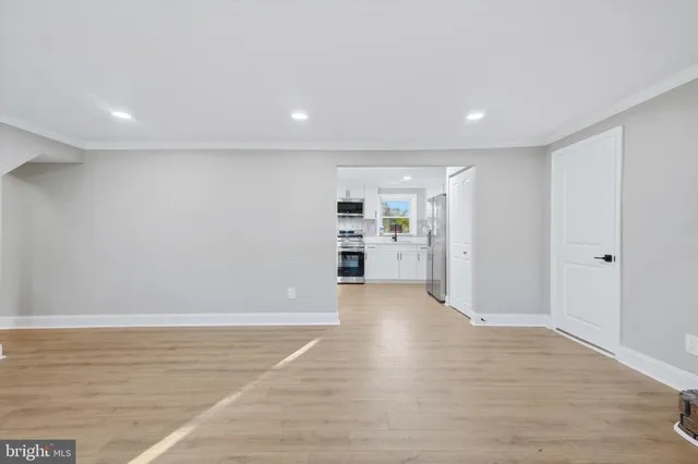 a view of a big room with wooden cabinet and windows