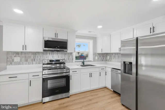a kitchen with a sink stove and refrigerator