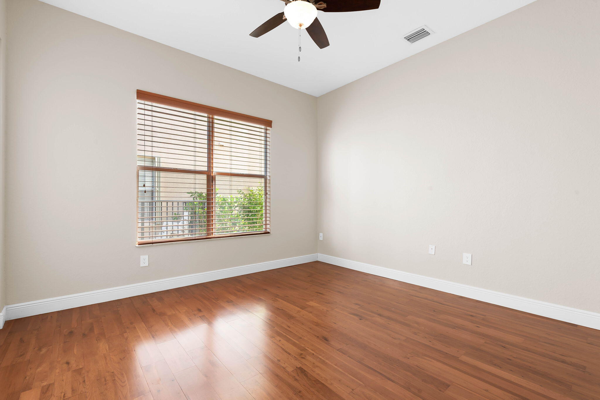 10774 Sunset Ridge Circle Boynton Beach, FL 33473 - Photo 15 of 39 wooden floor in an empty room with a window