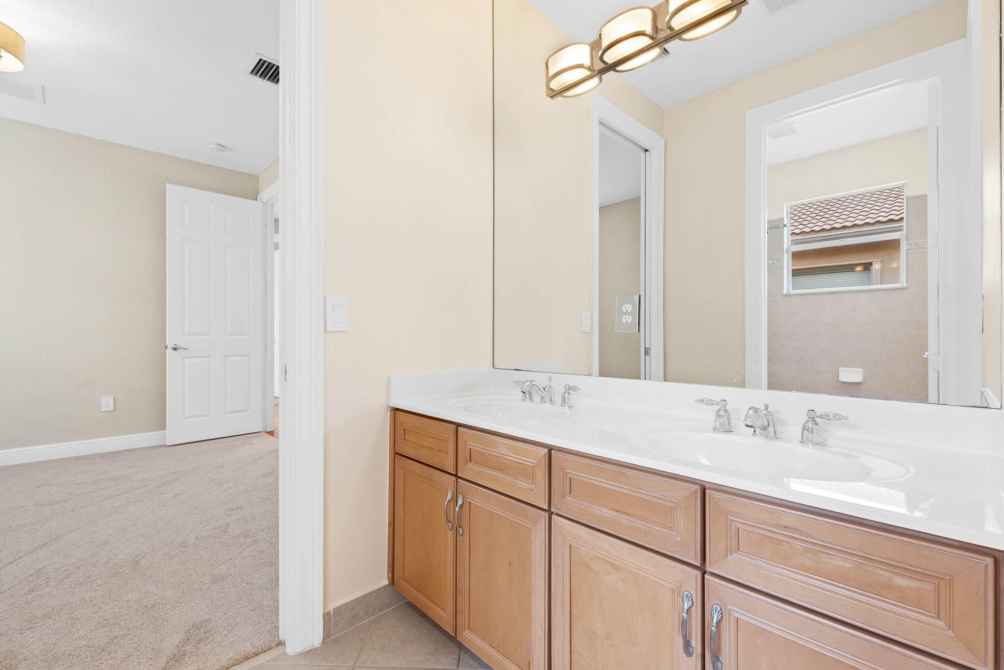 10774 Sunset Ridge Circle Boynton Beach, FL 33473 - Photo 19 of 39 a bathroom with a sink and a mirror