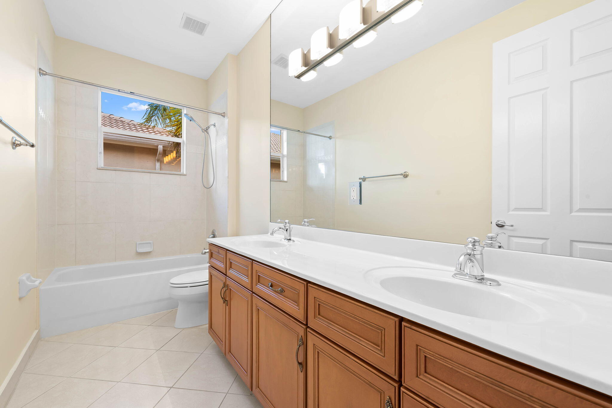 10774 Sunset Ridge Circle Boynton Beach, FL 33473 - Photo 23 of 39 a bathroom with a sink a toilet and shower