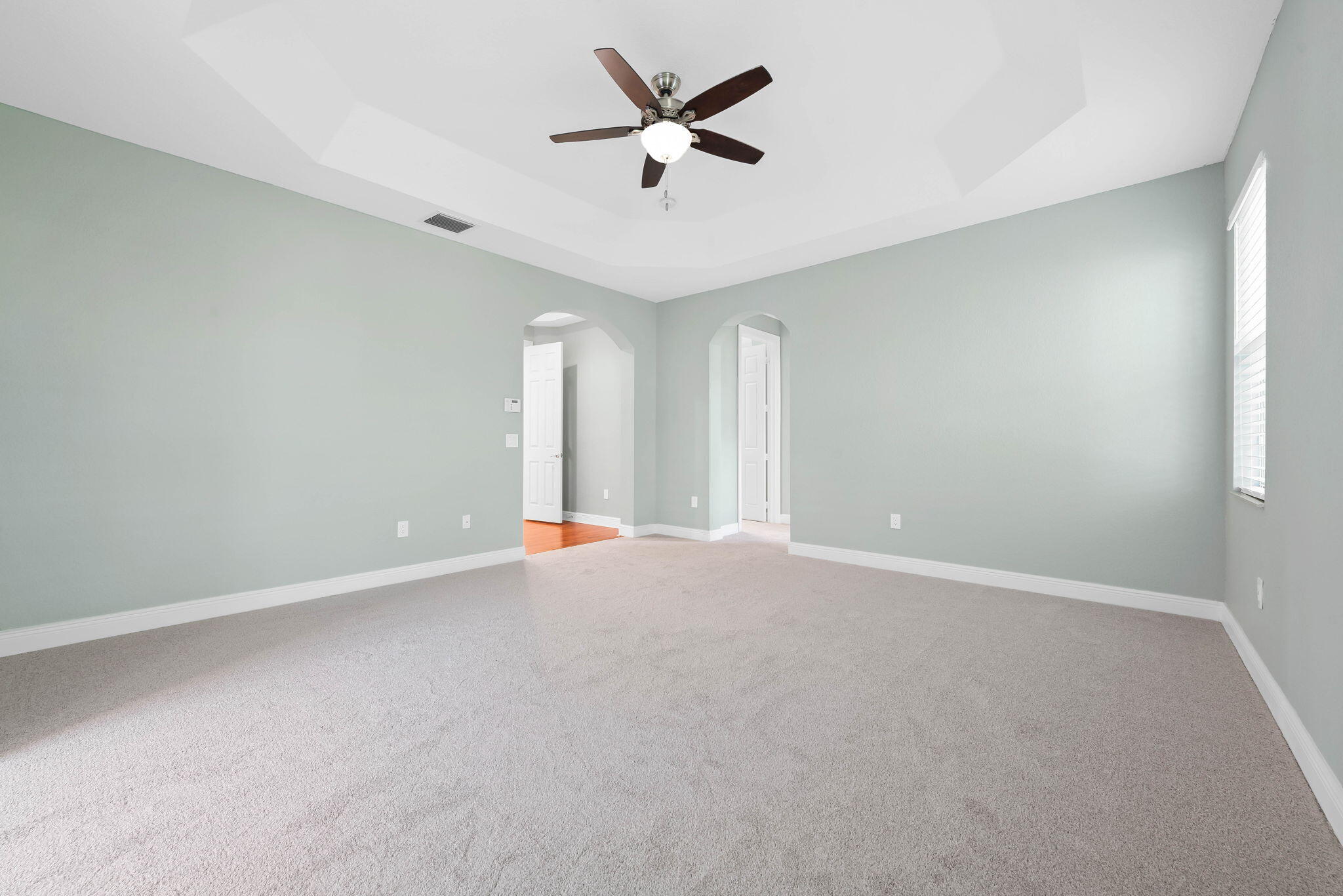 10774 Sunset Ridge Circle Boynton Beach, FL 33473 - Photo 30 of 39 an empty room with a ceiling fan and window