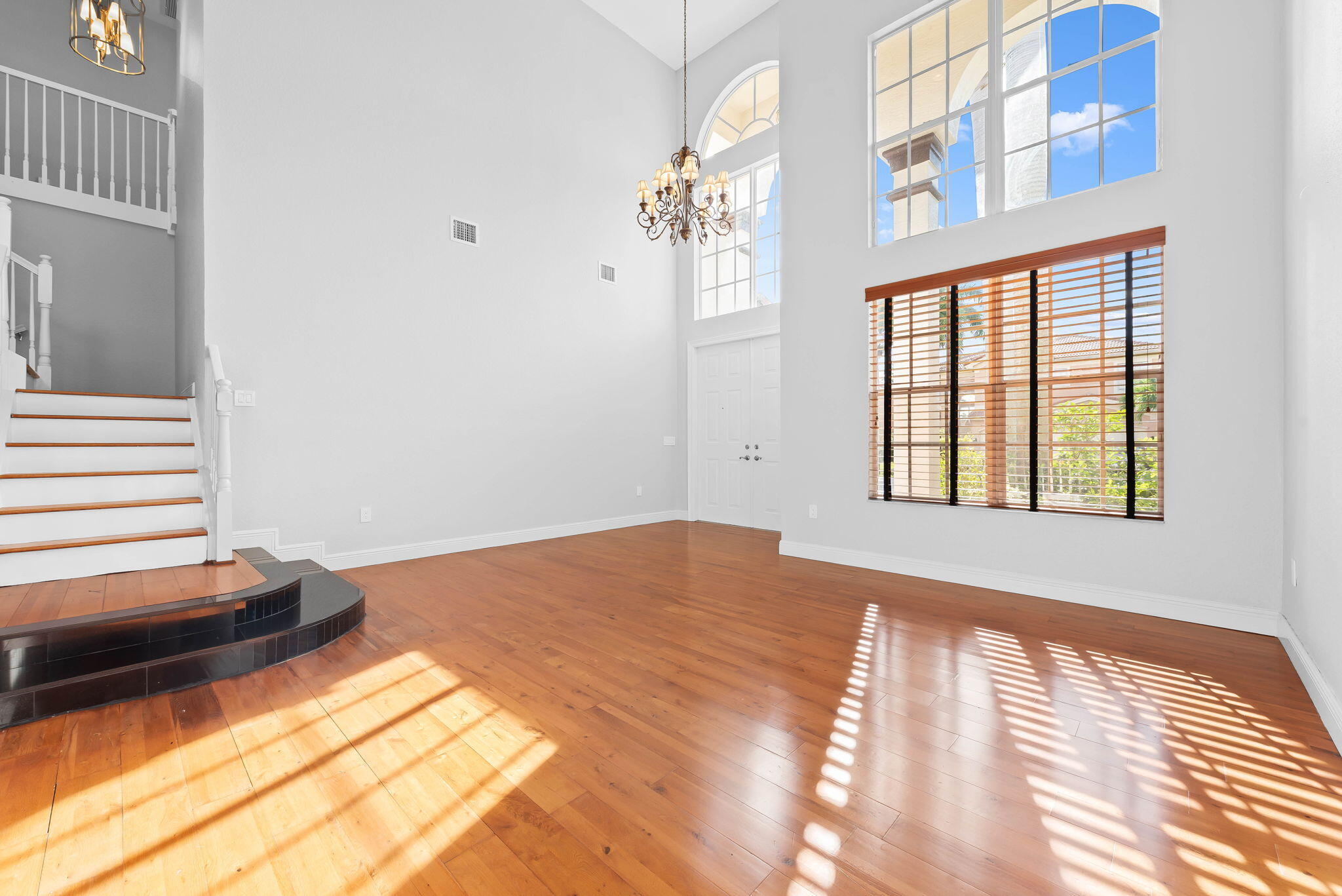 10774 Sunset Ridge Circle Boynton Beach, FL 33473 - Photo 3 of 39 a view of a bedroom with wooden floor and a window