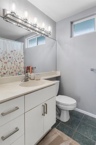 a bathroom with a sink a toilet and mirror