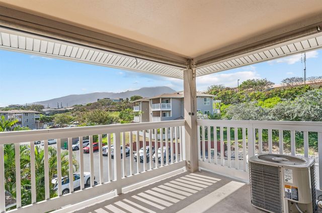 a view of a two chairs in the balcony