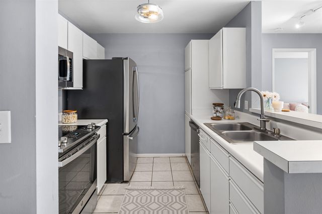 a kitchen with a sink stove and refrigerator