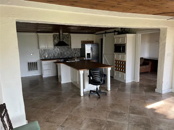 a kitchen with a sink and a stove top oven