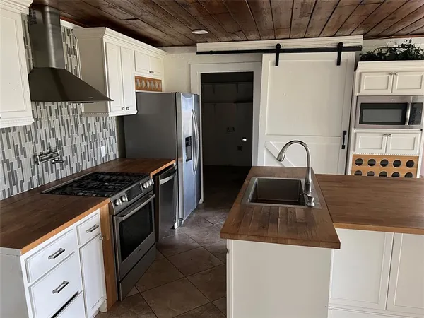 a kitchen that has a sink and a stove