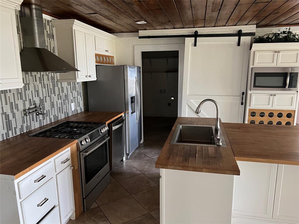 17313 West Beach Road Austin, TX 78734 - Photo 12 of 31 a kitchen that has a sink and a stove