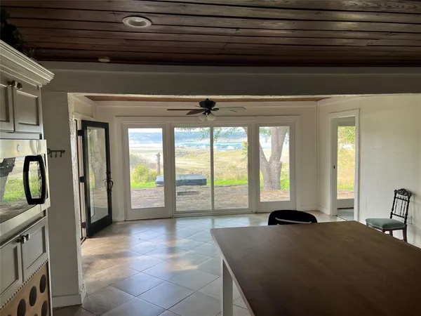 a living room with furniture and a floor to ceiling window