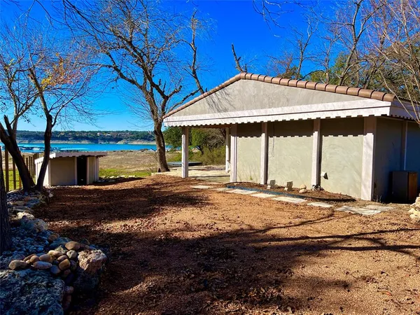 a backyard of a house with a shaded area