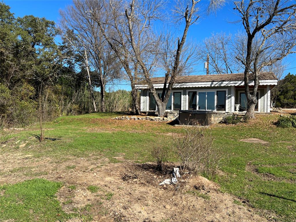 17313 West Beach Road Austin, TX 78734 - Photo 28 of 31 a front view of a house with a yard