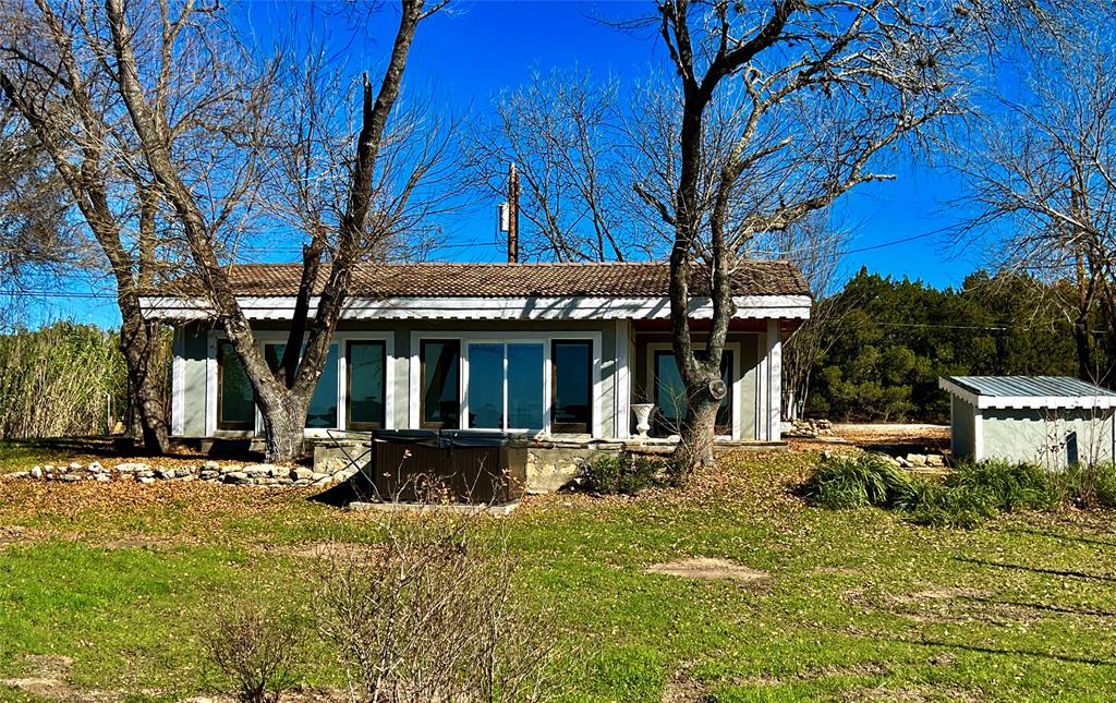 17313 West Beach Road Austin, TX 78734 - Photo 3 of 31 a front view of a house with garden