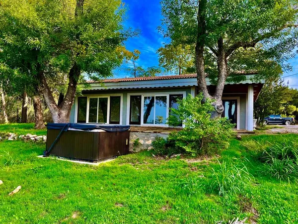 a view of house with a yard