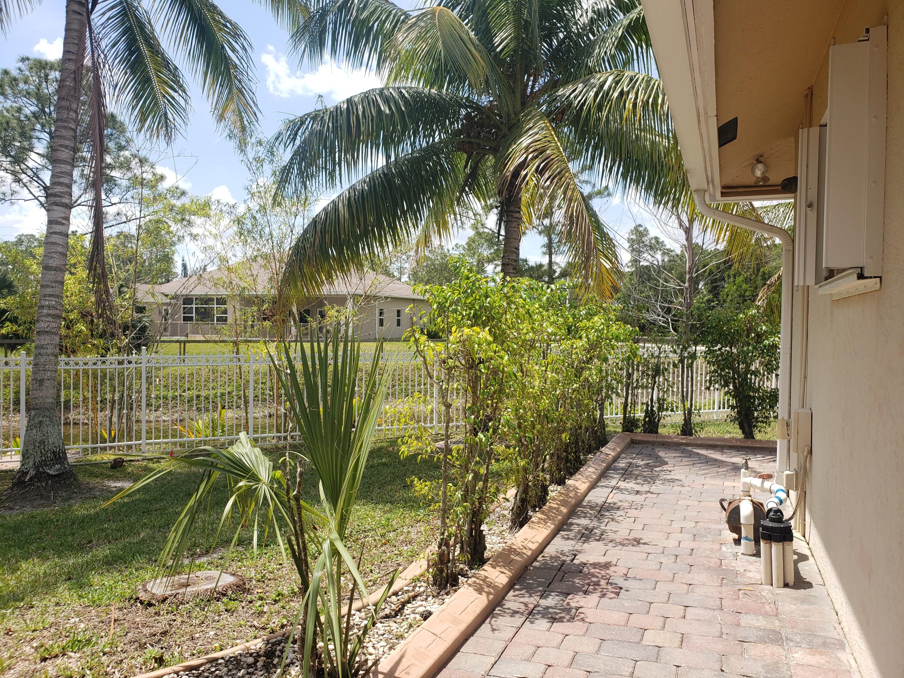 7260 Grapeview Boulevard Loxahatchee, FL 33470 - Photo 30 of 36 Walkway to Door