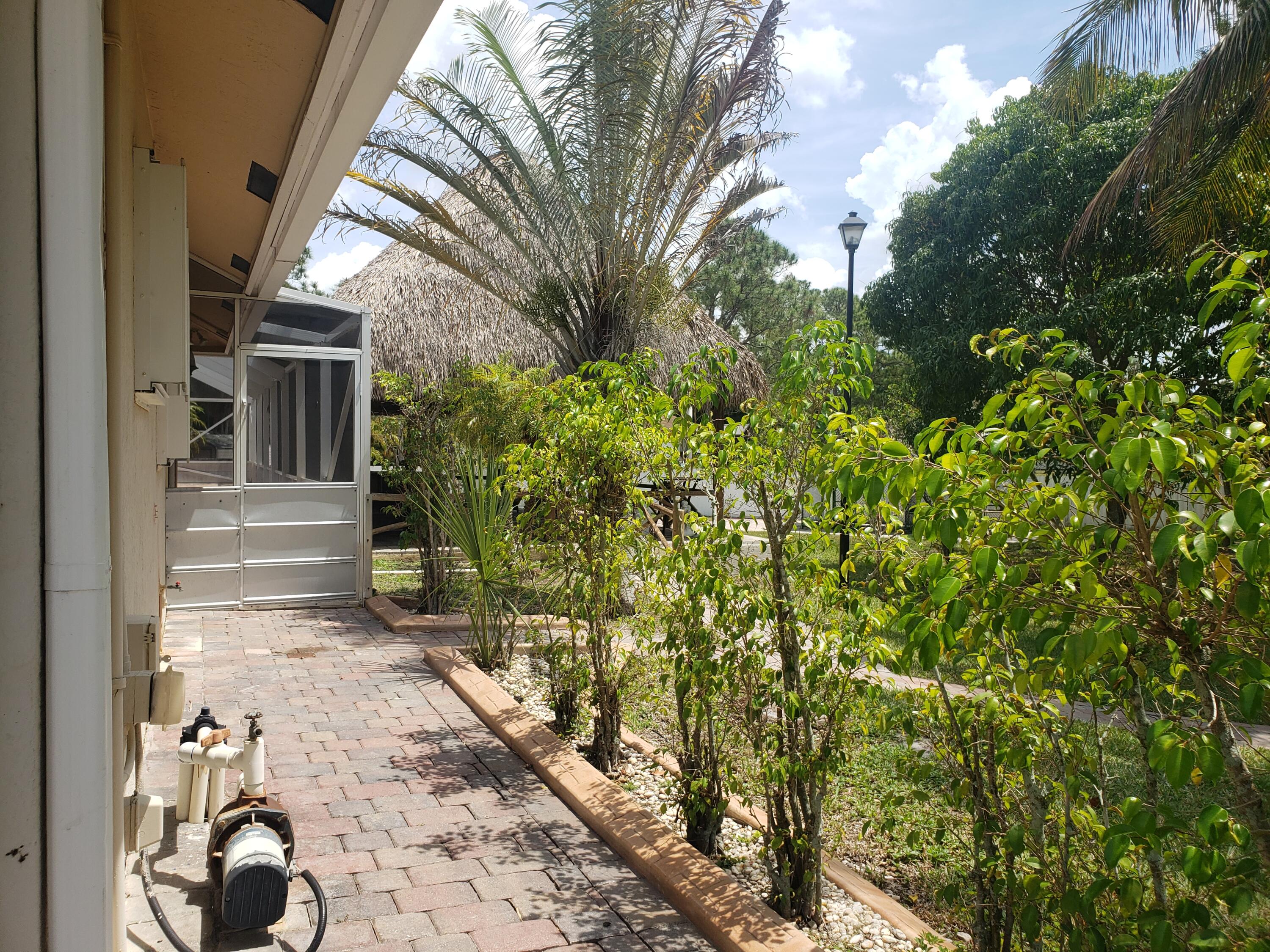 7260 Grapeview Boulevard Loxahatchee, FL 33470 - Photo 31 of 36 Walkway to Door