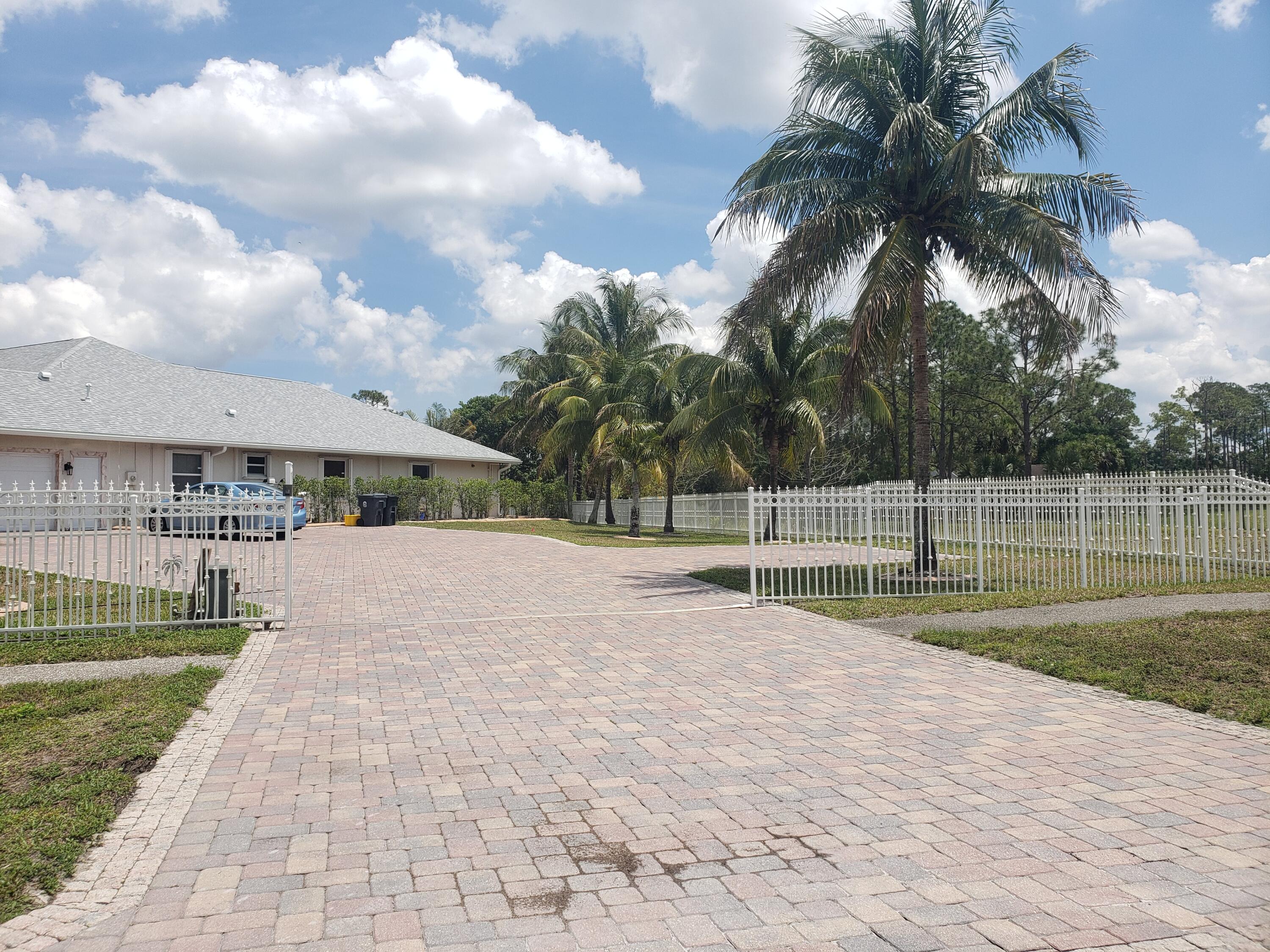 7260 Grapeview Boulevard Loxahatchee, FL 33470 - Photo 36 of 36 Gate and Driveway