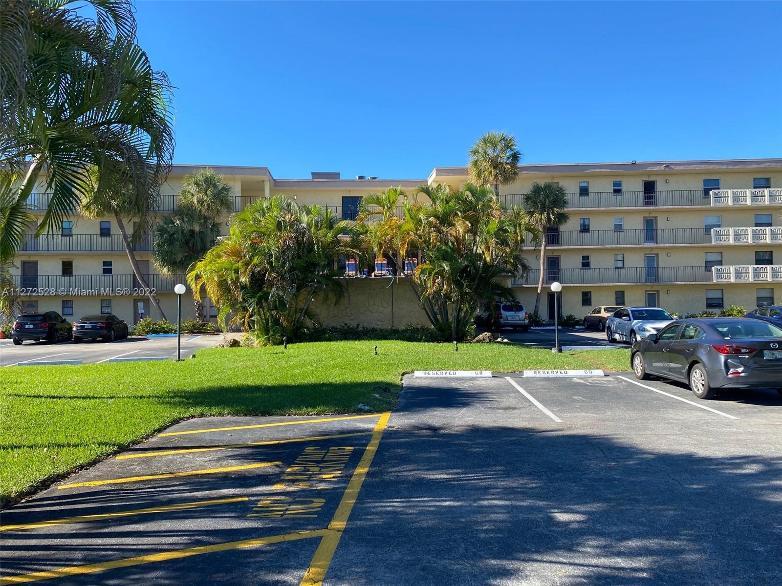 a view of a street with a cars parked